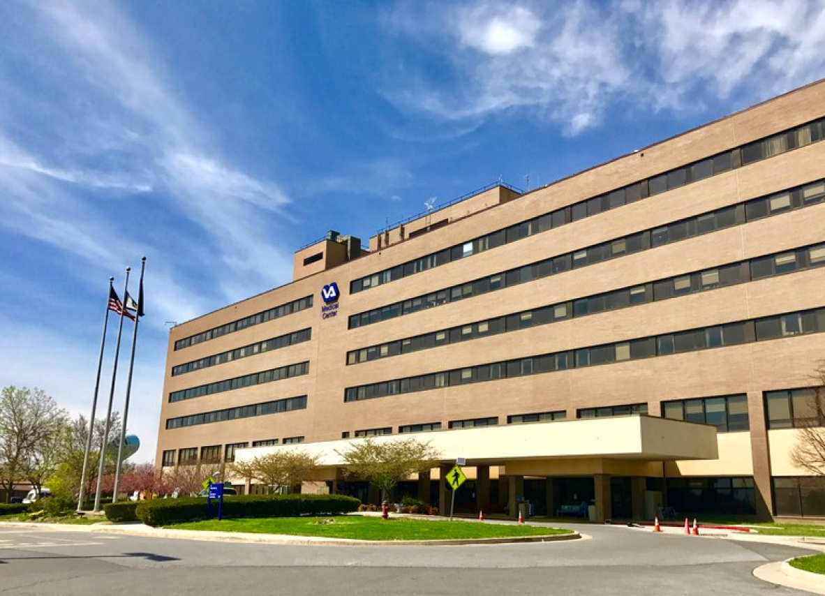 VA hospital building against a clear blue sky, highlighting its architecture and serene environment