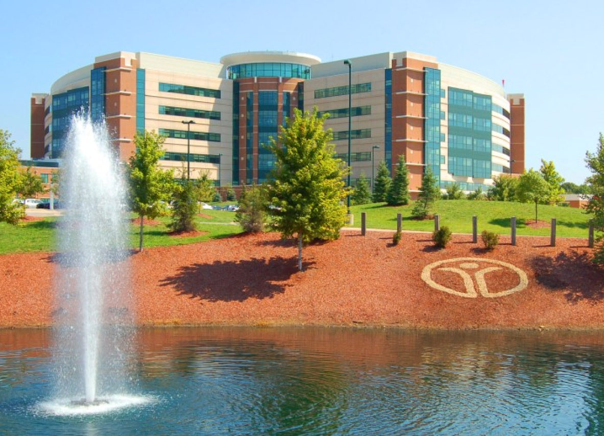 A large Reid Health building stands majestically with a fountain gracefully flowing in front of it