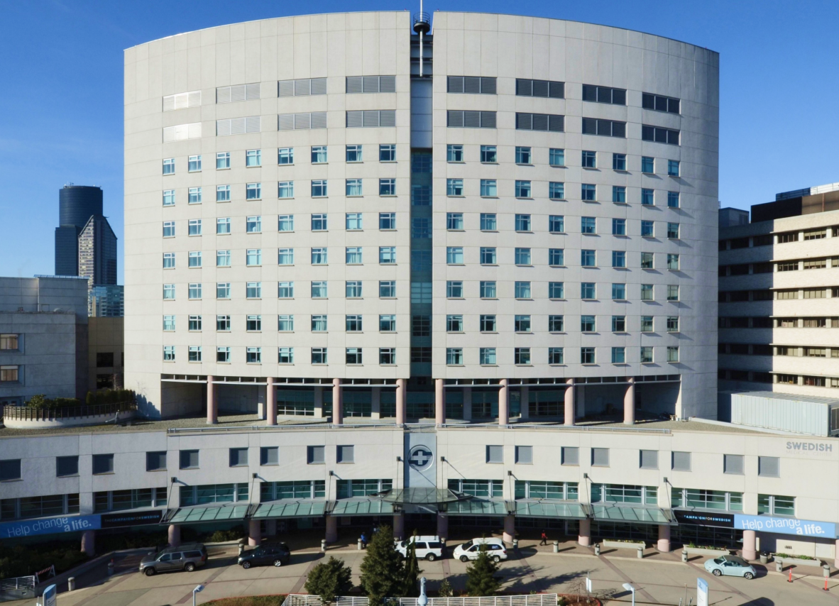 A hospital building set against a serene blue background, highlighting its architecture and surroundings